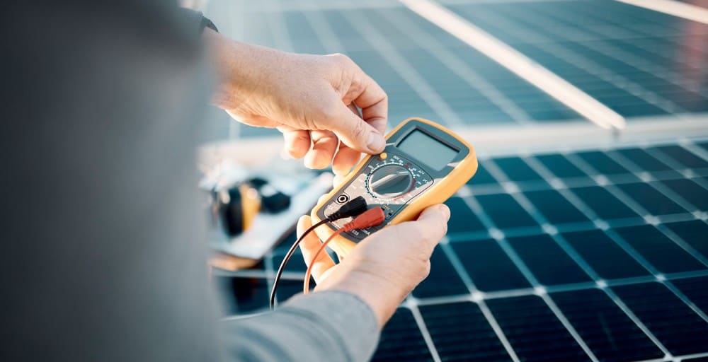 Detail Solar technician troubleshooting a residential solar system in Greenville