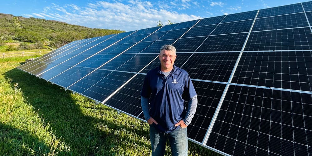 Detail Solar technician standing in front of a solar panel array