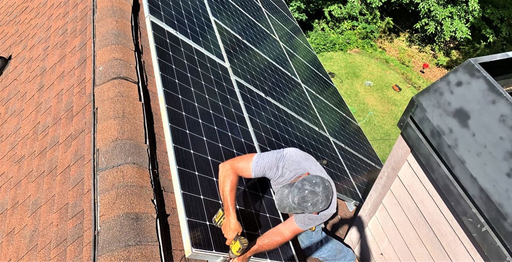 Detail Solar technician resetting a solar panel on a roof